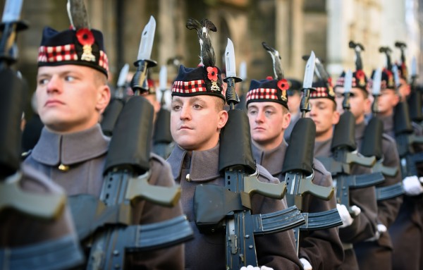 Soldiers from The Royal Regiment of Scotland wear poppies in their head-dress as a mark or respect on Edinburgh's Remembrance Sunday. 