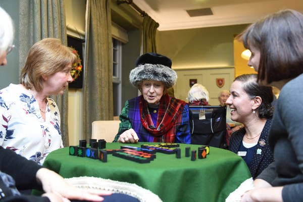 •Her Royal Highness Princess Alexandra chatting with residents and staff over a game of Qwirkle 