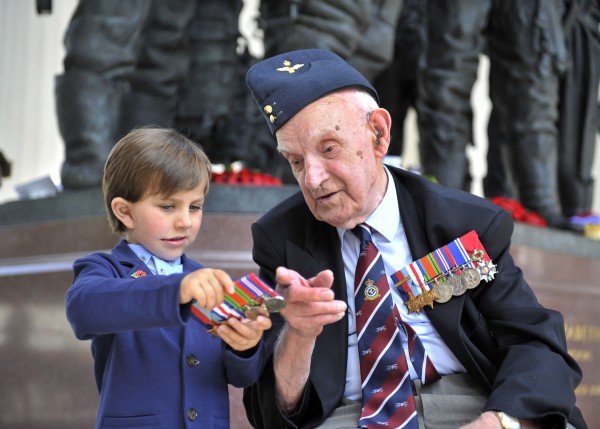 Left, Samuel Williamson, four, shows Bomber Command veteran Harry Rossiter his great great uncle Sgt Donald Eric Simmons’ medals. Sgt Simmons was killed in action during the Second World War, on 25 July 1944