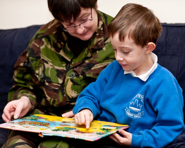 14/01/2011 - Aldershot, Hampshire. Stock photography to provide images for Reading Force initiative supported by the Commander 145 Bde and Kingston University. The project is a joint venture and is headed by Mrs Baverstock, wife of the brigade Commander, 145 Brigade and intends to encourage Army families to encourage reading amongst their children and other service families. The Reading Force initiative is support by several schools in the Aldershot area and the program should go live in April 2011. Central to the idea is the formation of local book reading groups which will discuss the books they have read and complete scrapbooks about the books. The images will be used in advertising material from the scheme. NB: Model release forms held for all children and adults involved in the photoshoot. Seen here; Joshua Harrison and his mum, Major Rebecca Harrison, ETS, read a pirate book for the Aldershot led Reading Force initative.